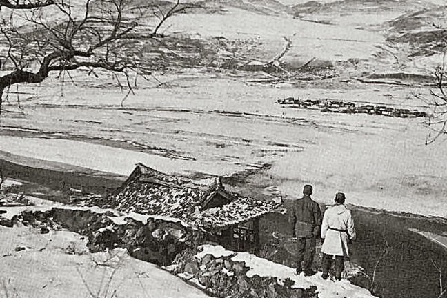 ON THE BANKS OF THE YALU, two soldiers look across the valley into the mountains of Manchuria..jpg