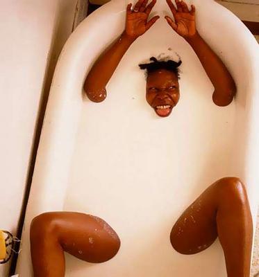 Whoopi Goldberg in a bath full of milk.