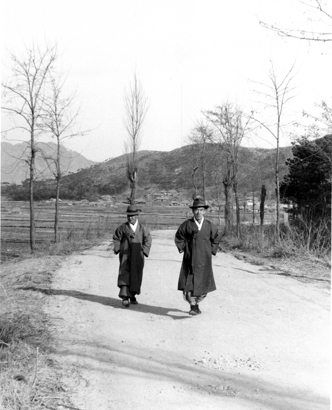 Two men in traditional dress on a road, 1973.jpg