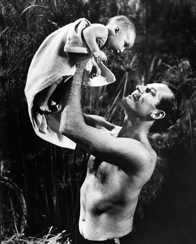 Actor Charlton Heston lifting two-month-old son Fraser..jpg