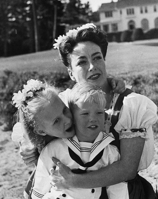 Joan Crawford hugging her two adopted children..jpg