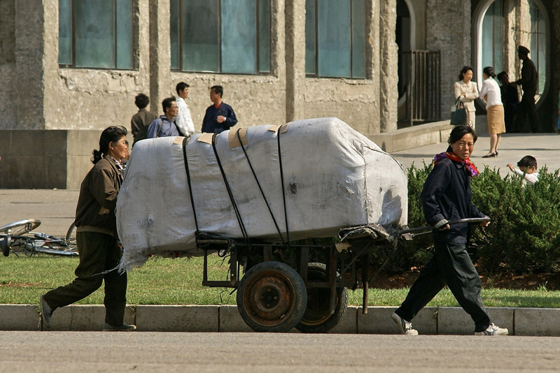 Women carrying goods in Kwangbok Street, Pyongyang.jpg