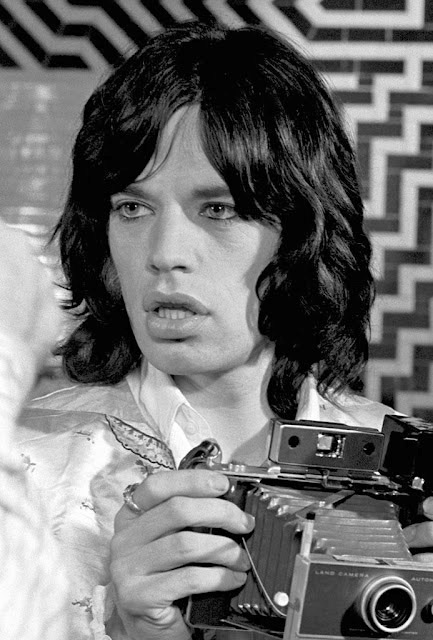 Mick-Jagger-with-a-Polaroid-Image-by-Baron-Wolman.jpg