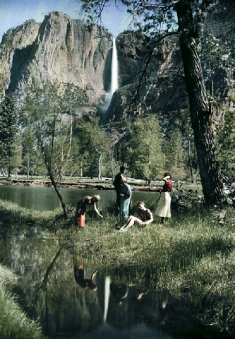 California-A-family-on-the-bank-of-a-water-body-with-a-view-of-a-cliff-waterfall.jpg