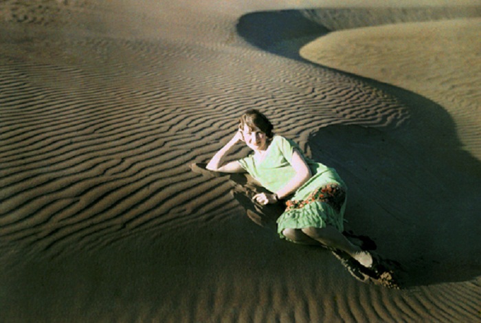 California-A-woman-poses-in-rippled-sand-dunes-near-Crescent-City.jpg