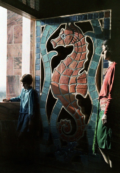 Florida-A-child-and-an-adult-stand-by-a-tiled-sea-horse-at-the-Carillon-Tower-Iron-Mountain.jpg