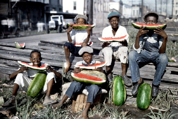 Louisiana-Five-boys-sit-together-eating-large-watermelon-slices-New-Orleans.jpg