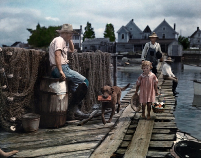 Maryland-A-child-and-her-dog-walk-down-the-dock-to-meet-the-mail-boat-Tylerton.jpg