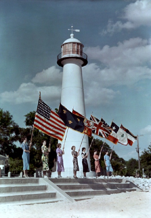 Mississippi-Women-hold-seven-flags-at-site-of-historic-lighthouse-in-Biloxi.jpg