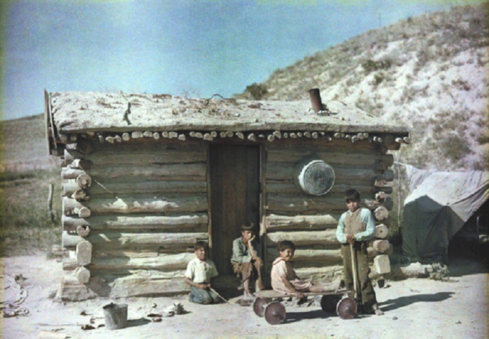 South-Dakota-Boys-pose-outside-a-sod-roof-house-at-the-Pine-Ridge-Reservation.jpg