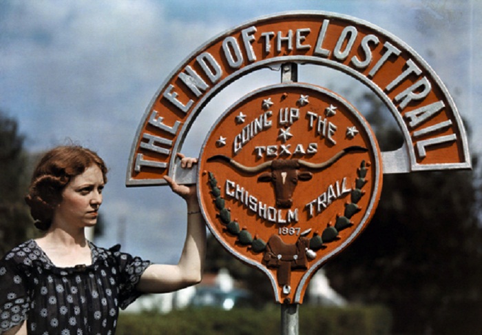 Texas-A-woman-stands-next-to-a-sign-at-the-end-of-the-International-Bridge-Brownsville.jpg
