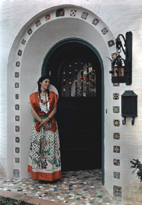 Texas-A-young-girl-stands-in-costume-at-the-archway-to-her-home-Brownsville.jpg
