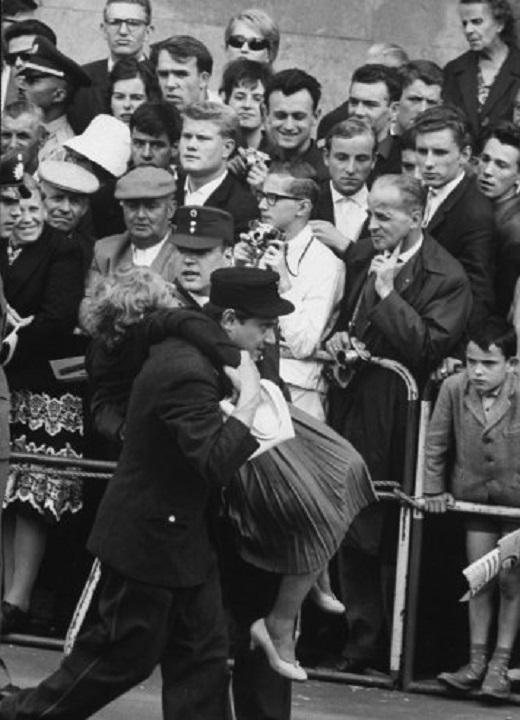 07 Fainting woman carried by Red Cross workers during commotion caused by President Kennedy