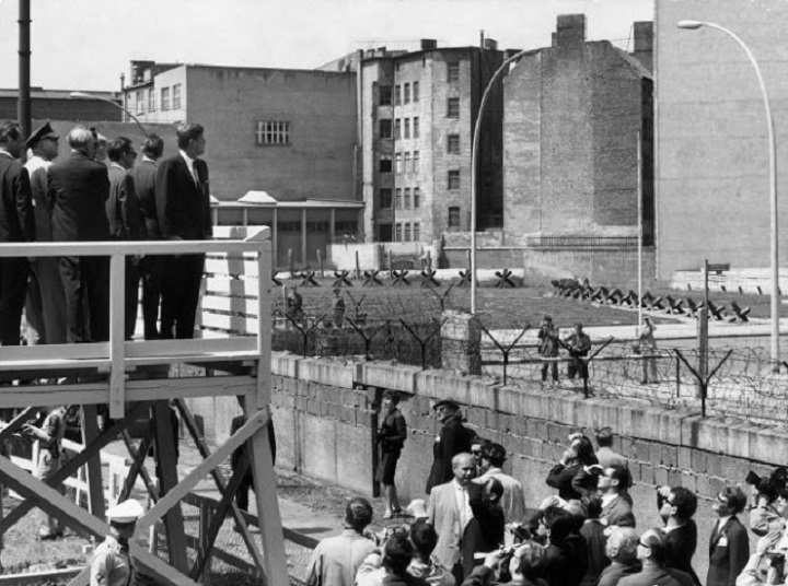 11 From a viewing stand, President John F_ Kennedy gazes over the Berlin Wall into East Germany, June 1963.jpg