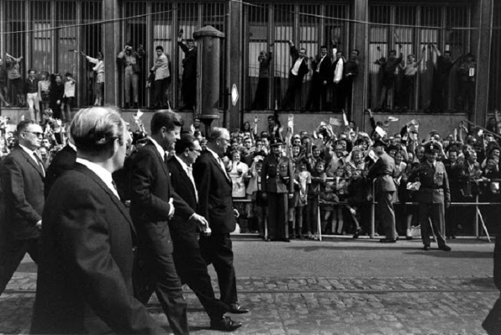17 President John F_ Kennedy walks with dignitaries during his June 1963 visit to Germany.jpg