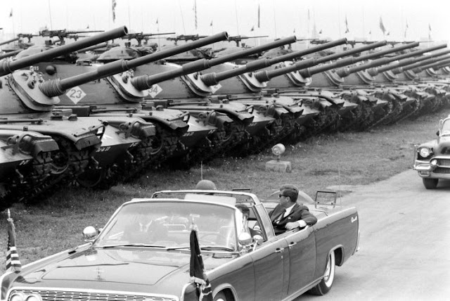 24 President John F_ Kennedy, in open limo, reviews the U_S_ Army