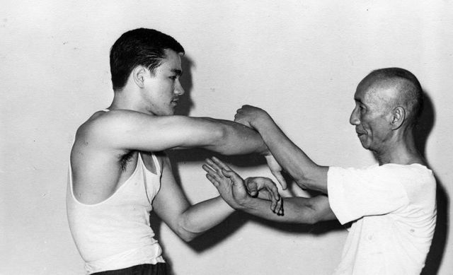 A very young Bruce Lee spars with Ip Man in 1955..jpg