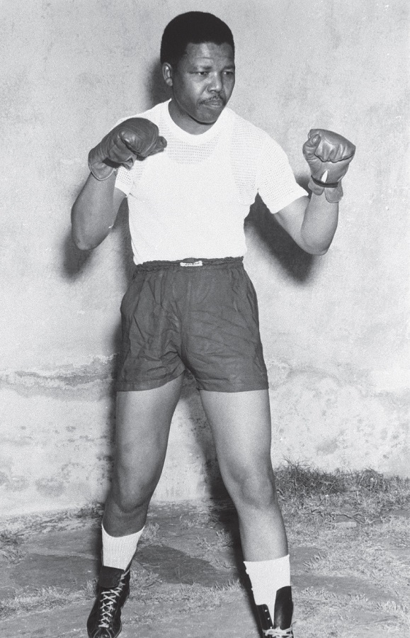 A young Nelson Mandela poses in his boxing outfit, 1950..jpg
