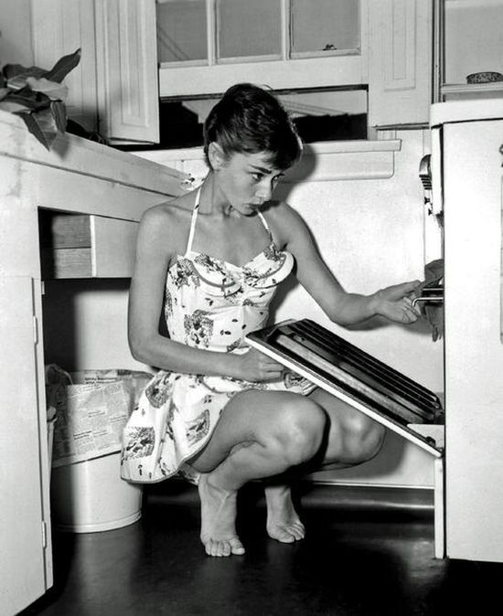 Style icon 23-year old Audrey Hepburn, barefoot, in home dress, plates, 1952.jpg