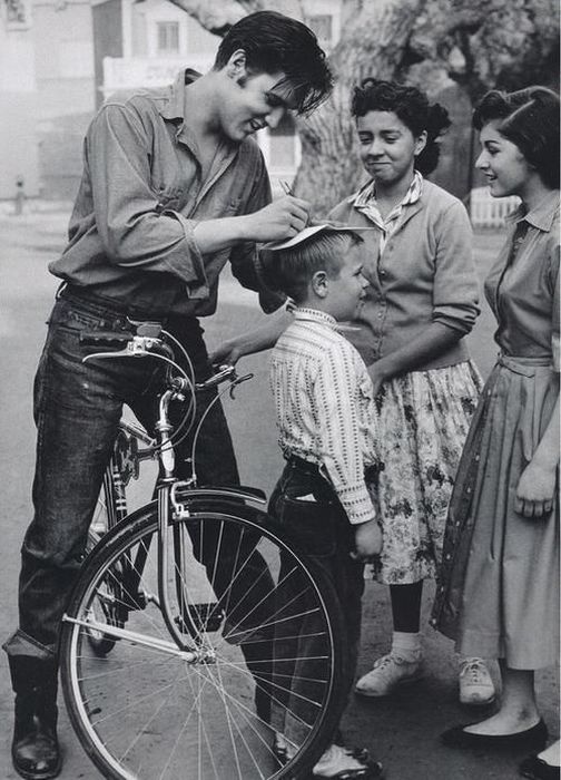 Elvis Presley gives an autograph on the head boy, 1959, United States.jpg