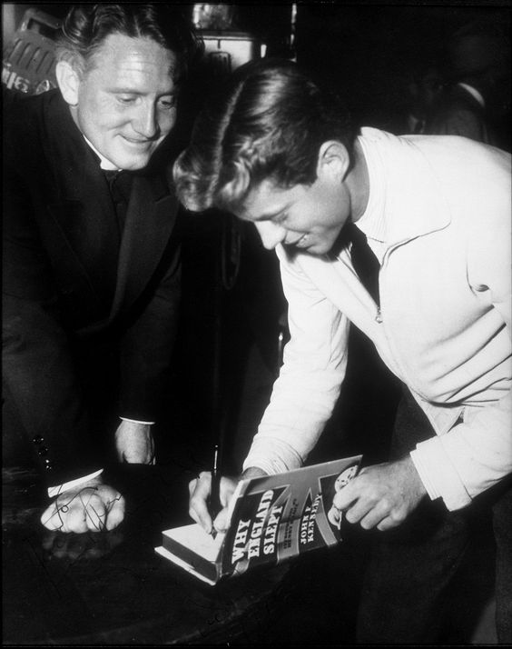 Twenty-three year old John F. Kennedy signs a copy of his book Why England Slept for actor Spencer Tracy. Hollywood, CA, Nov 1940.jpg