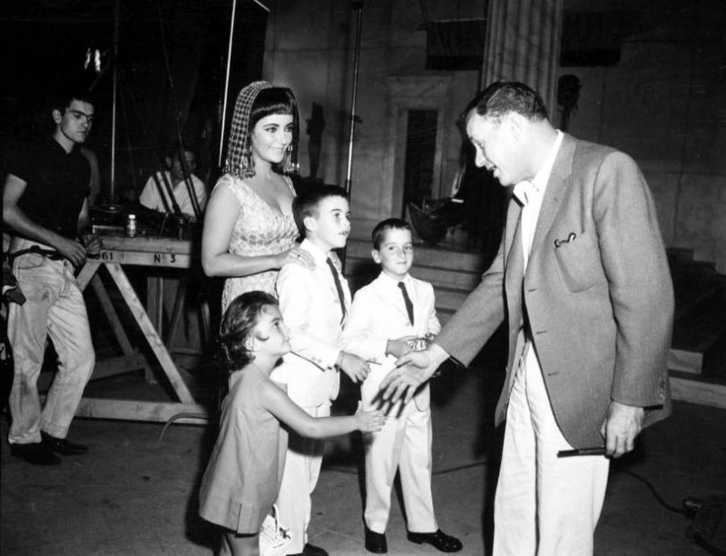 On the set of Cleopatra, Elizabeth Taylor introduces her children Liza, Michael Howard and Christopher Edward to director Joseph L. Mankiewicz..jpg