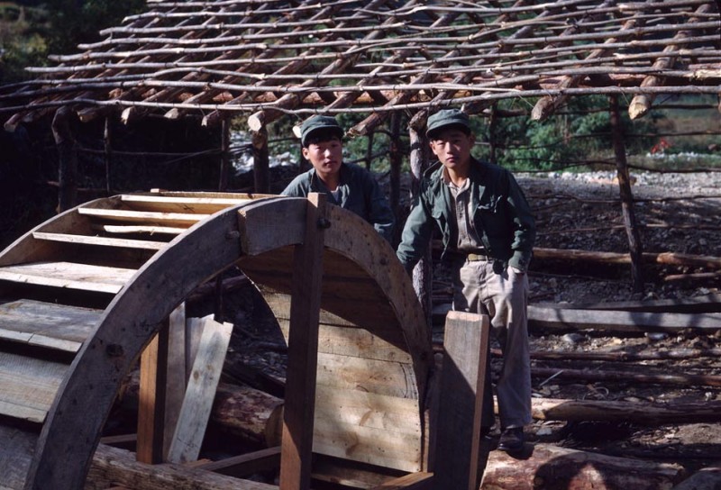37 Han and Lee inspecting water wheel for rice mill.jpg