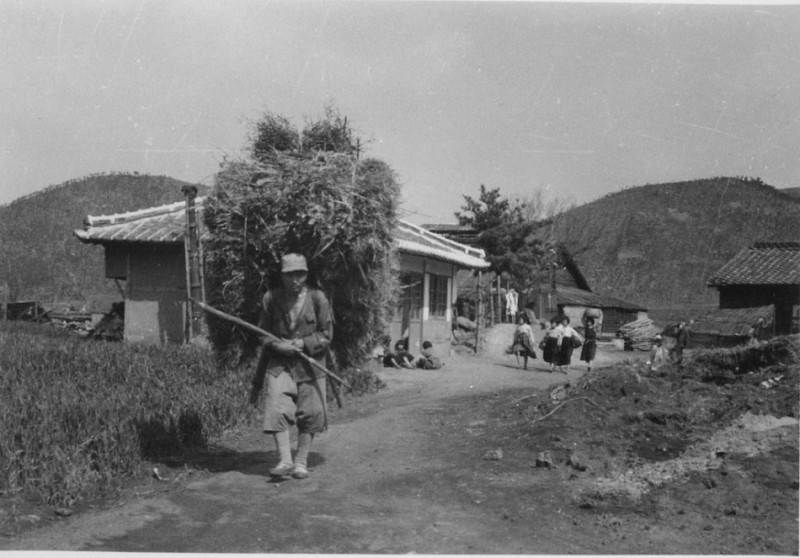 64b A country scene-notice what a load the man has on his back Aug 1952.jpg