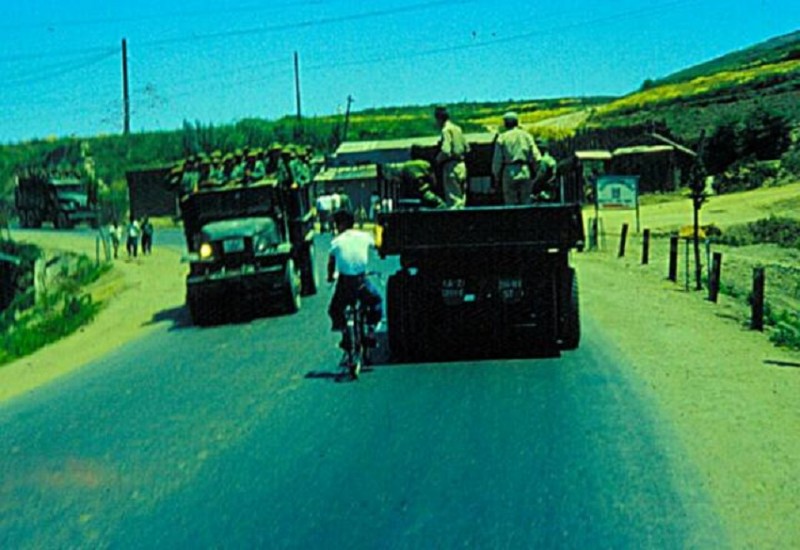 10 ROK ARMY TRUCKS MAN ON BYCLE HITCHING A TOW ON ONE OF THE TRUCKS 1955.jpg